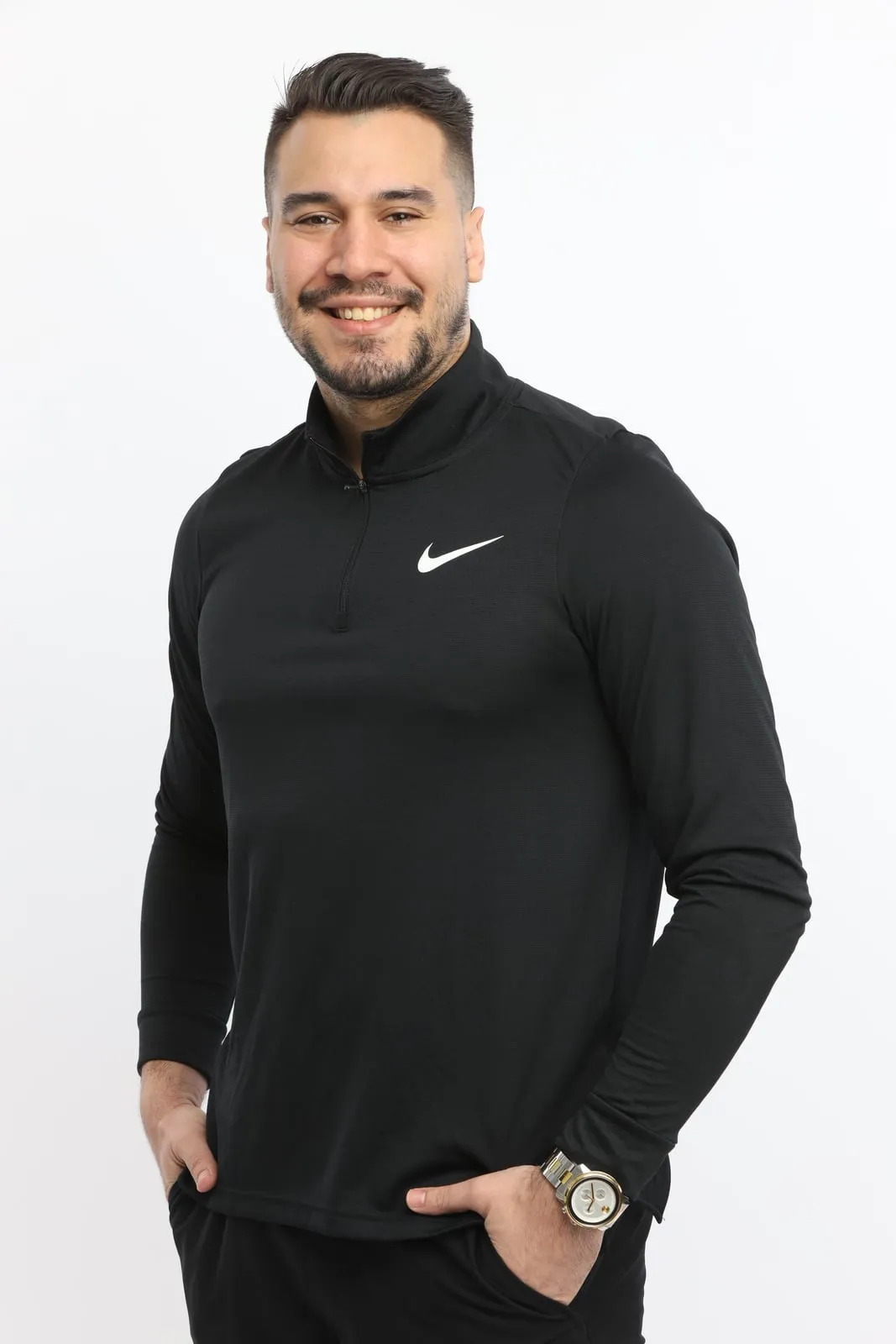 Roman Izquierdo, Roman Your Physio, registered physiotherapist in Toronto, smiling, in a black athletic quarter-zip