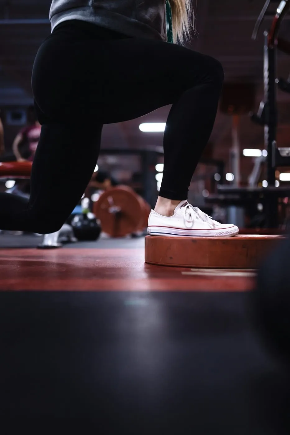 Legs stepping up onto a box in a gym